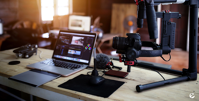 Live streaming equipment set up with laptop, microphone, and camera.