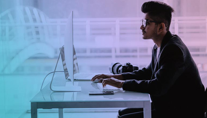 Man on computer attending a live virtual event.